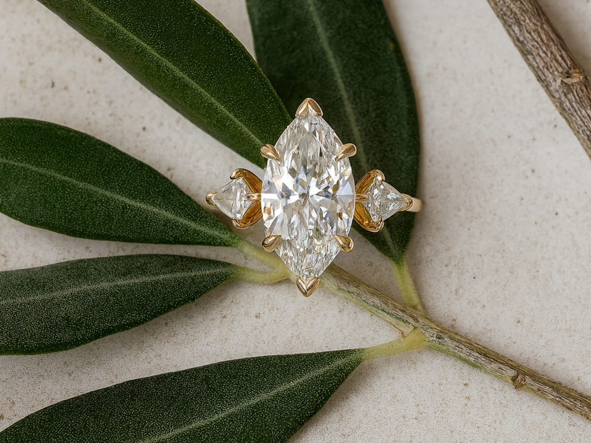 Custom-designed marquise diamond three-stone engagement ring from Diamonds Above, styled on olive branch