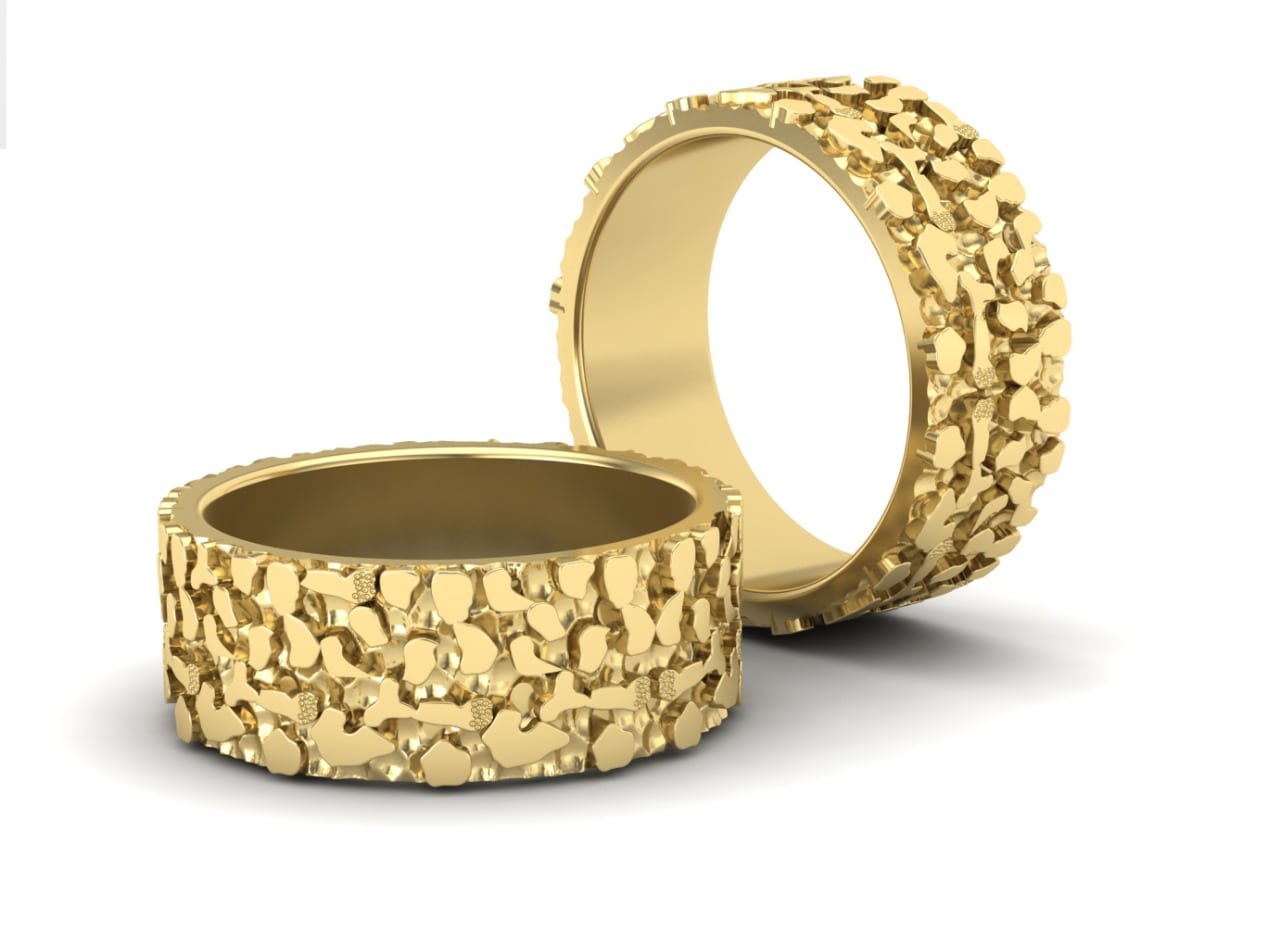Wide textured nugget-finish band pair in 18kt yellow gold with organic faceted surface