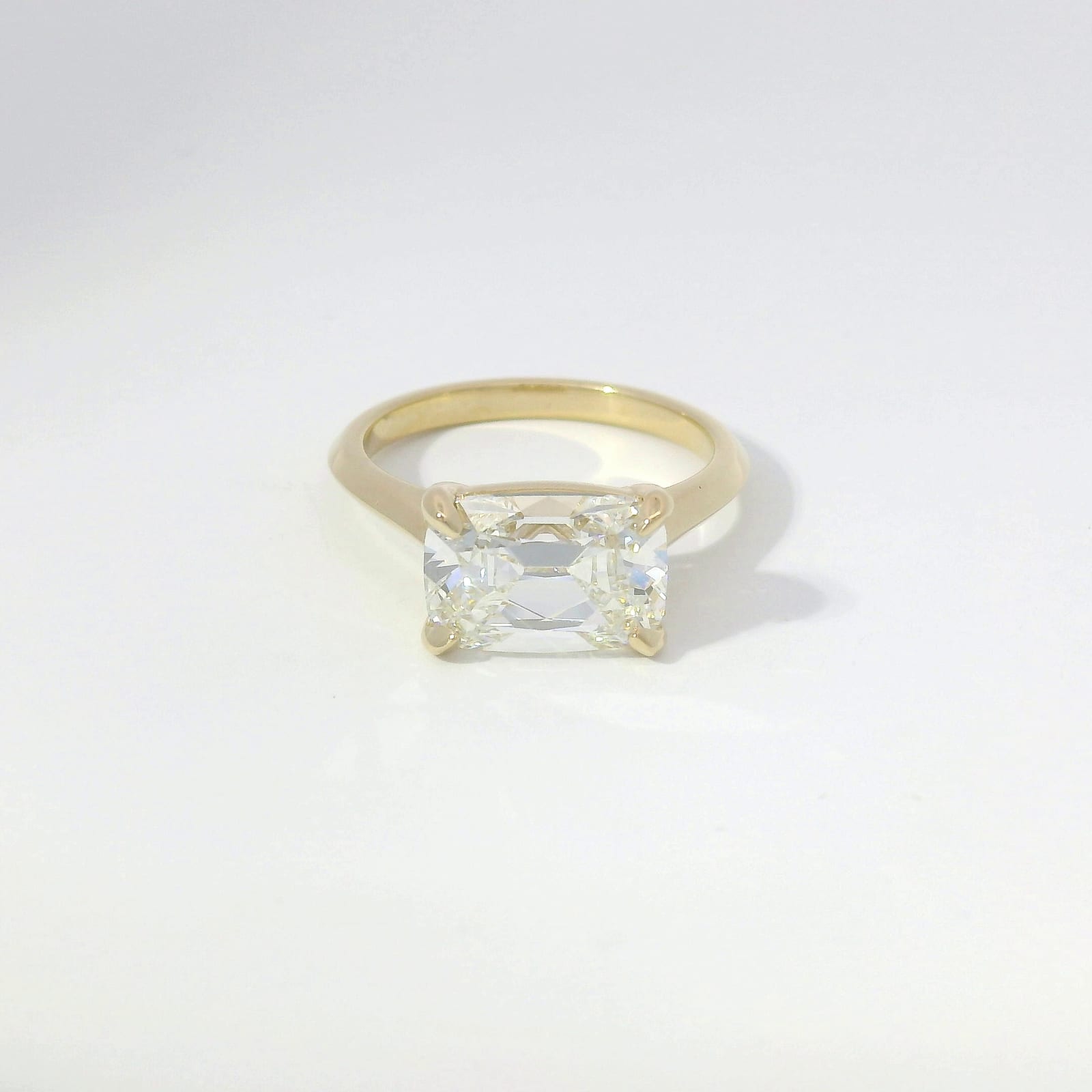 East-west cushion rose-cut diamond solitaire in yellow gold with knife-edge band