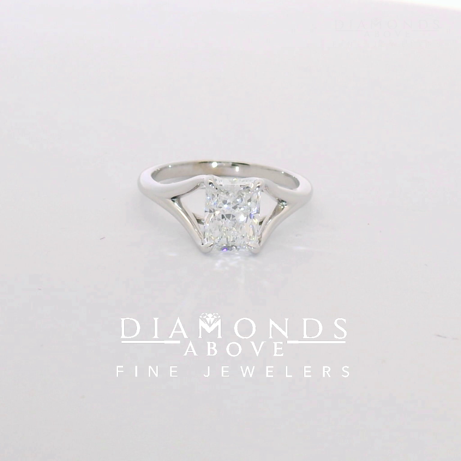 Radiant-cut diamond solitaire on a polished split shank in white gold