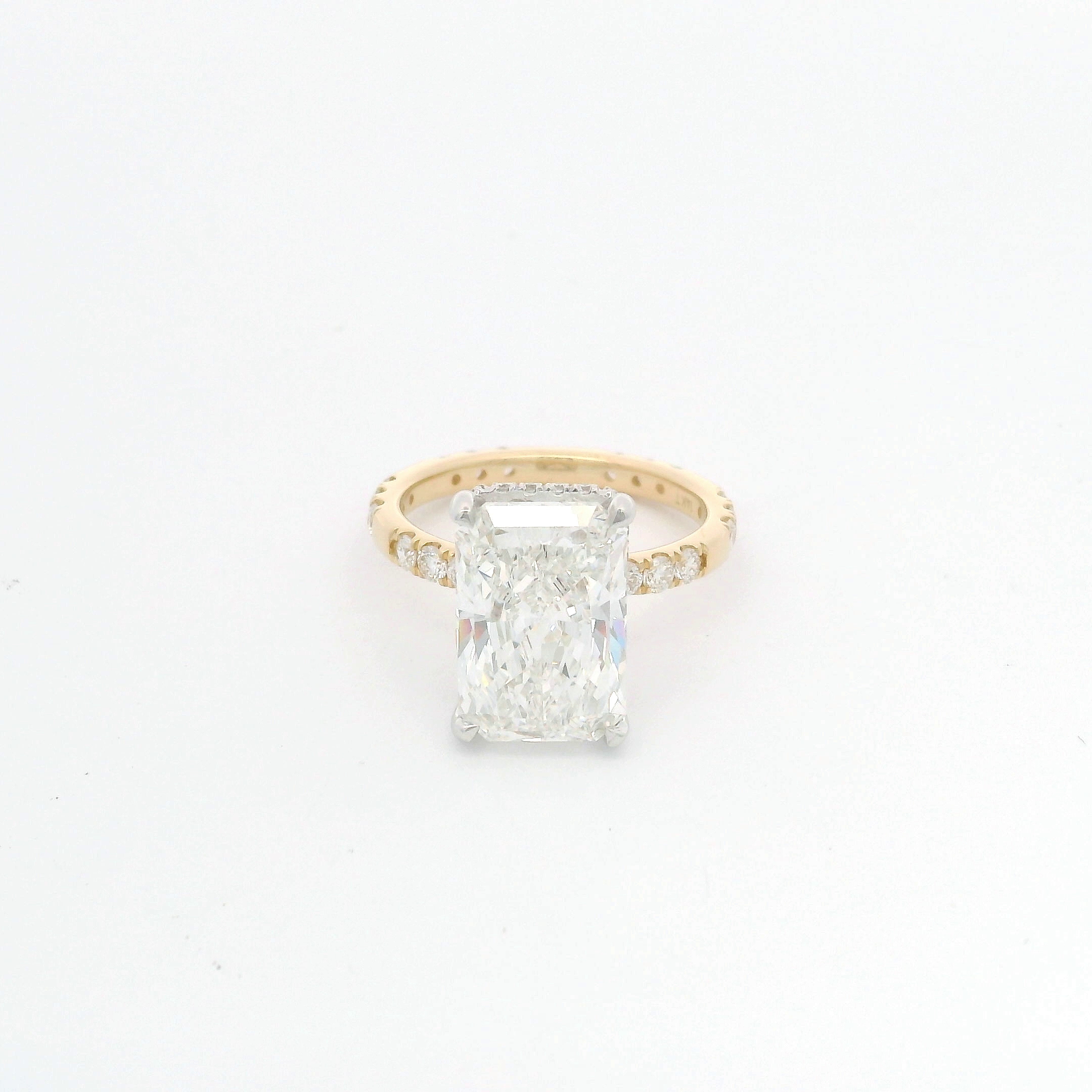 Radiant-cut diamond solitaire with pavé eternity band in two-tone gold