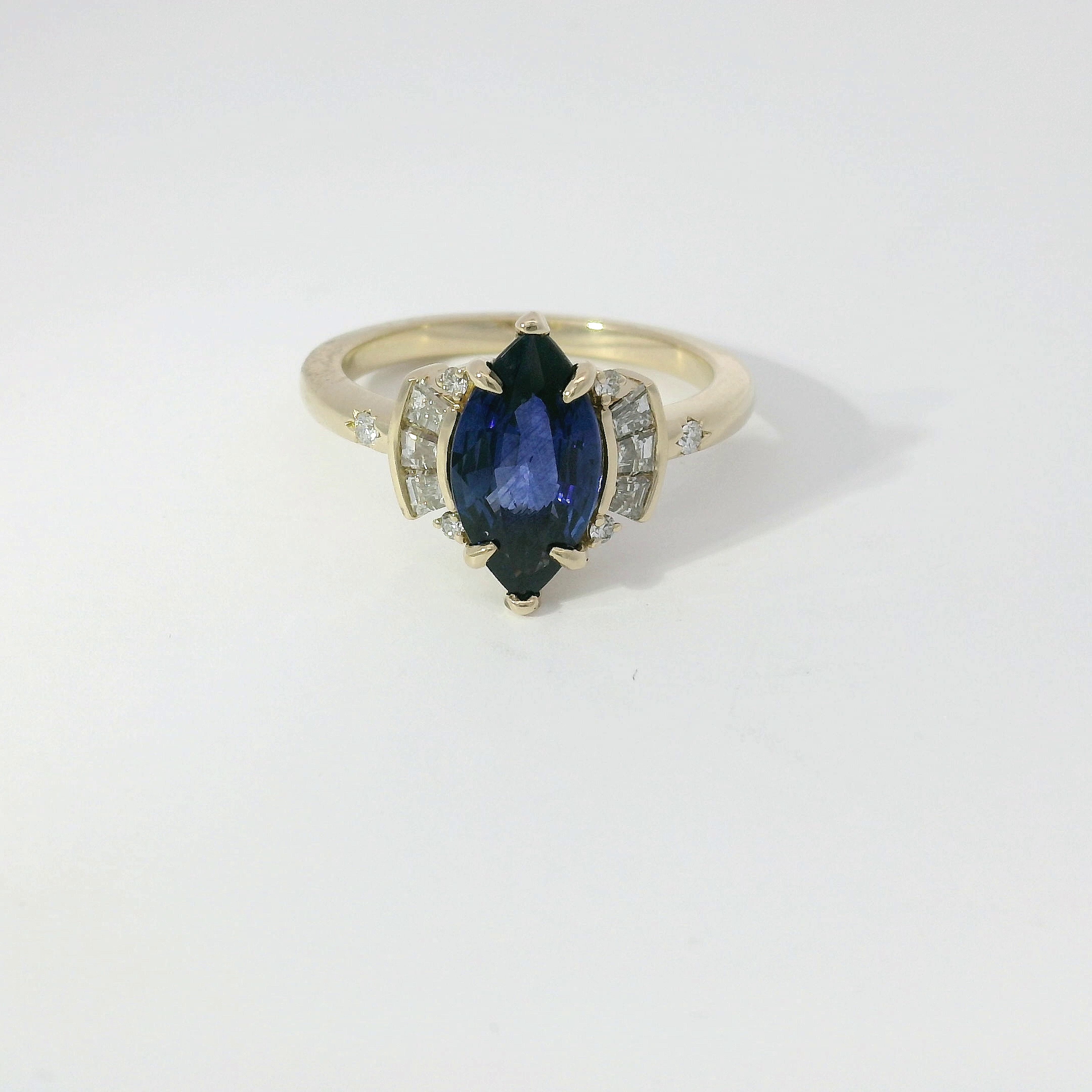 Marquise blue sapphire with art-deco diamond accents in yellow gold