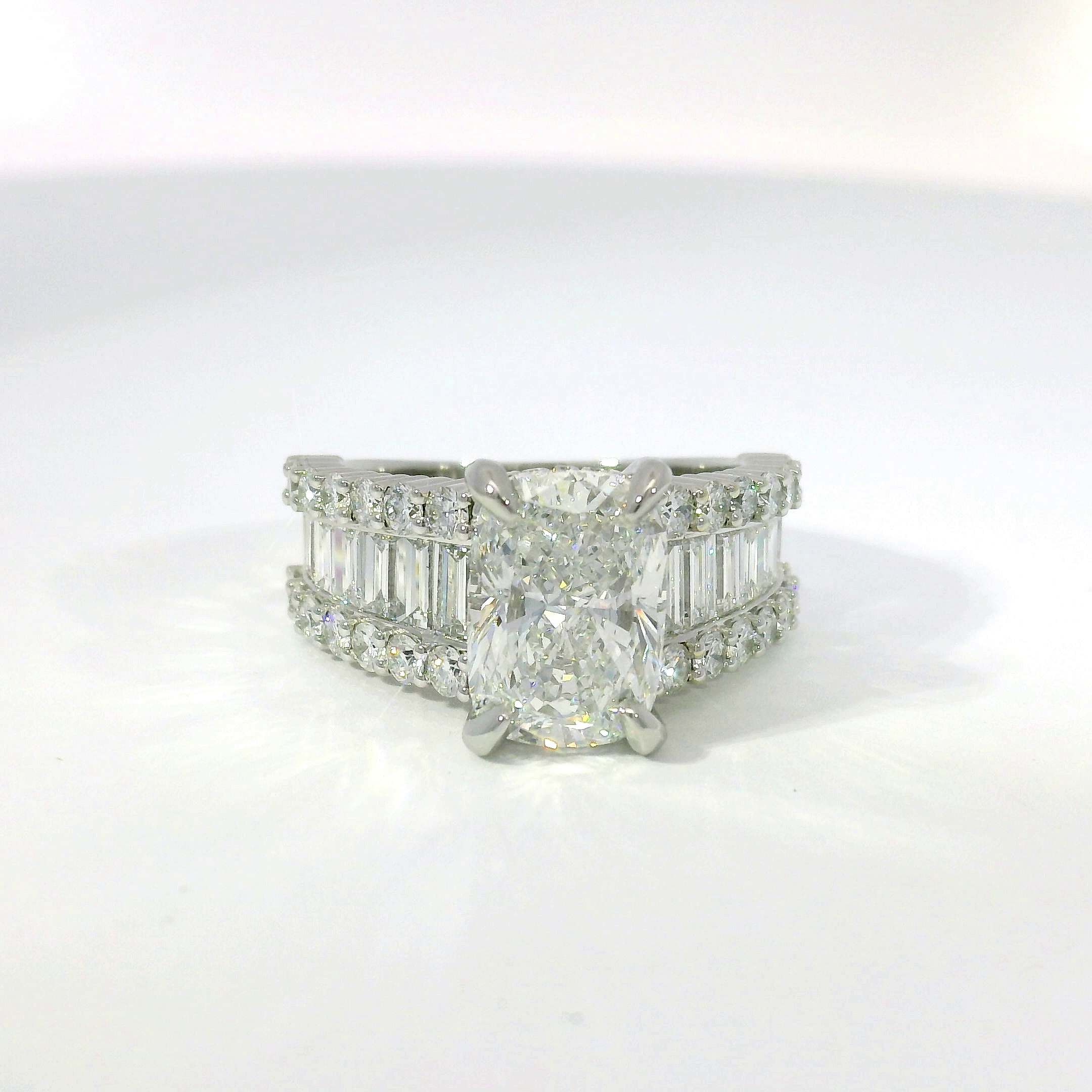 Cushion-cut diamond with channel-set baguette and pavé band in white gold
